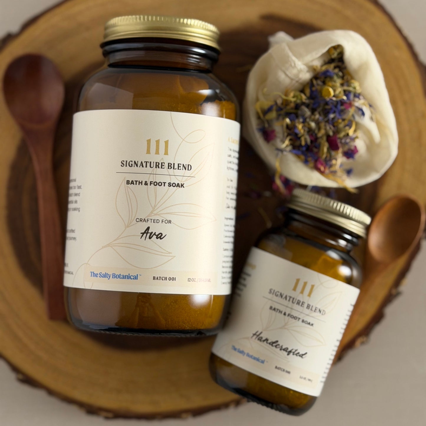 Two jars of 111 Signature Blend bath and body products on a wooden surface.