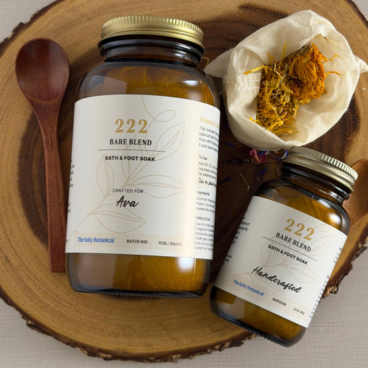 Two jars of 222 Bare Blend bath and body products on a wooden surface.